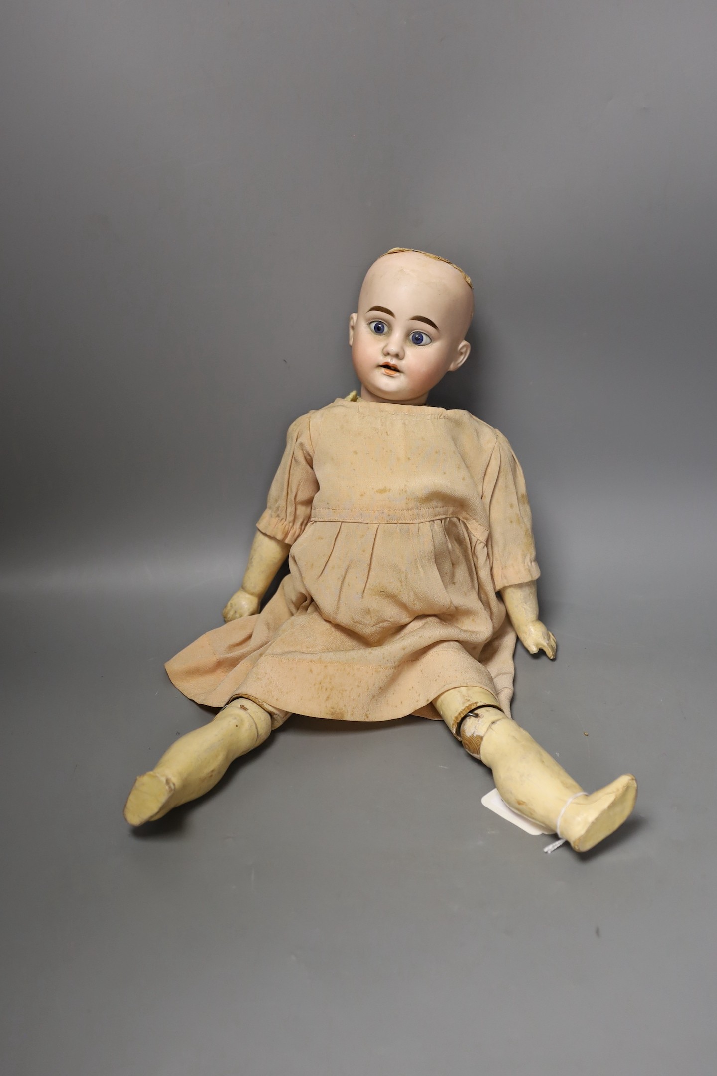 An Armand Marseille bisque headed doll, another German bisque headed doll and a miniature bisque doll.